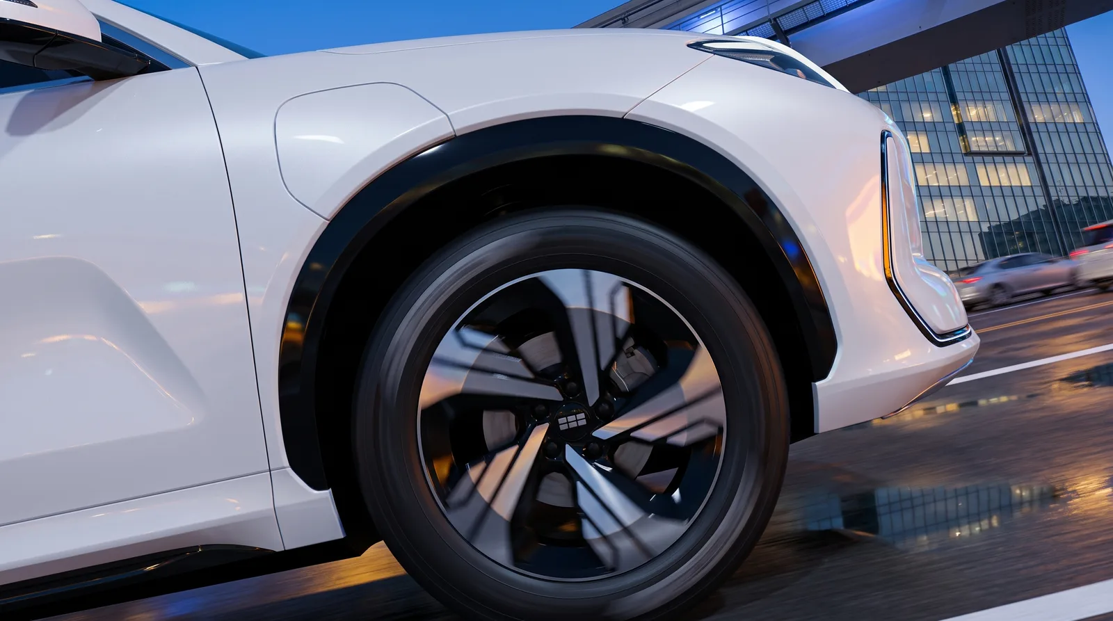 Front wheel and arch detail against lit city towers