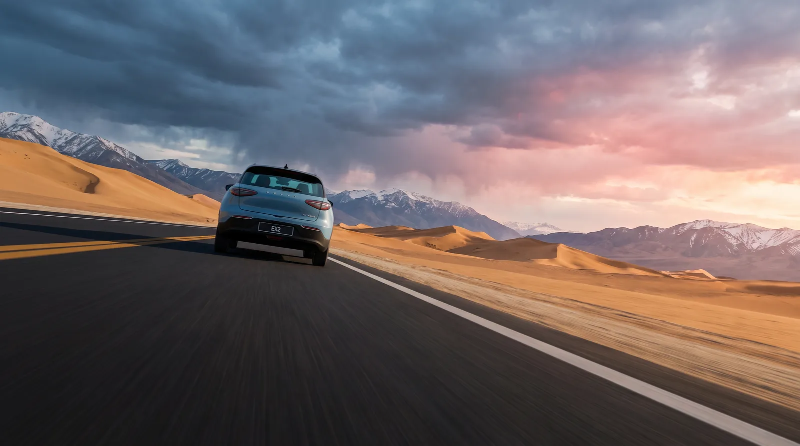 Steel-blue SUV on a desert highway under storm light